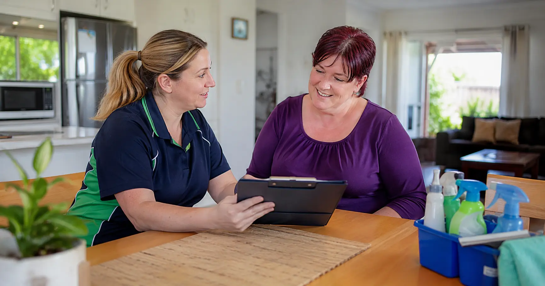 NDIS house cleaner preparing a quote with a participant for ndis house cleaning rates in Brisbane